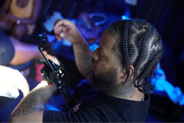 Cedric tattooing a client in the shop