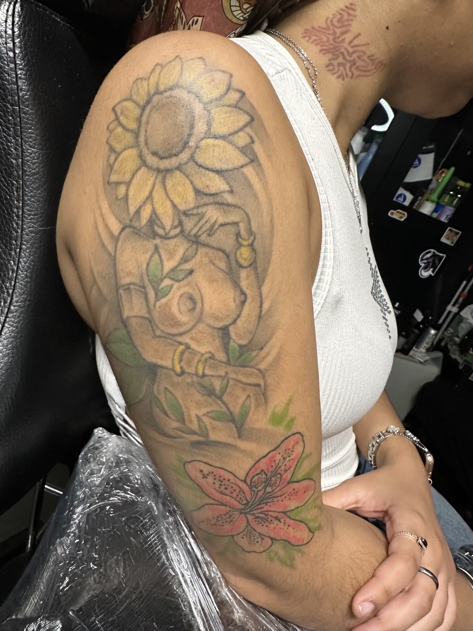 Before: faded sunflower figure tattoo