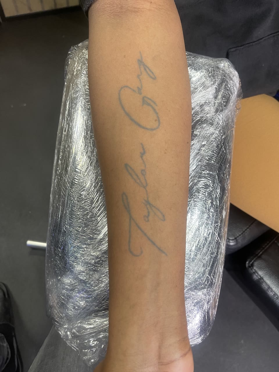 Before: faded script tattoo
