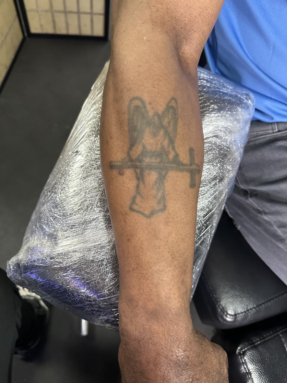 Before: faded angel and cross tattoo