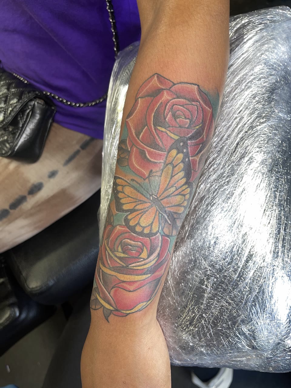 After: roses and butterfly cover-up tattoo