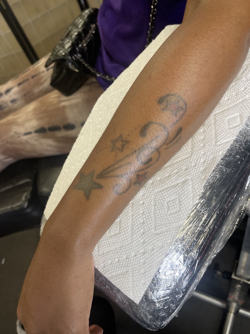Before: faded stars and scroll tattoo