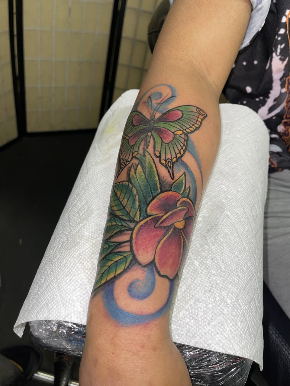After: colorful butterfly and flower cover-up tattoo