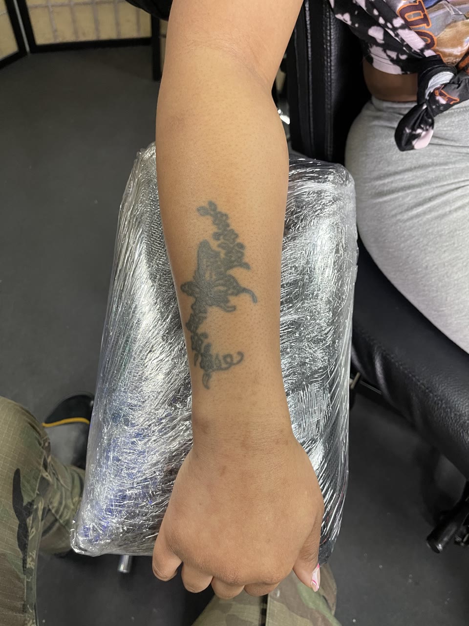 Before: faded butterfly and script tattoo